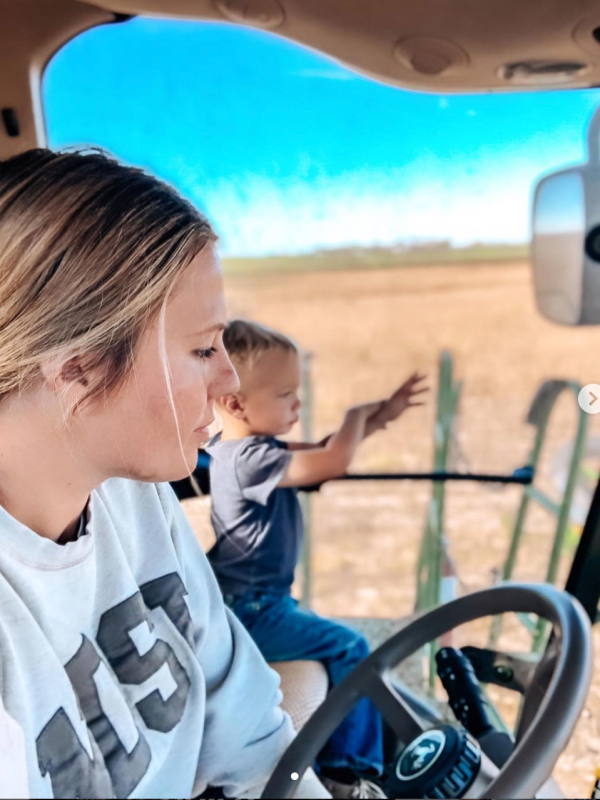 farmer combining with son in buddy seat
